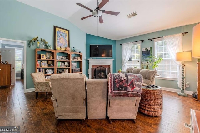 living room with lofted ceiling, ceiling fan, a fireplace, and dark hardwood / wood-style flooring