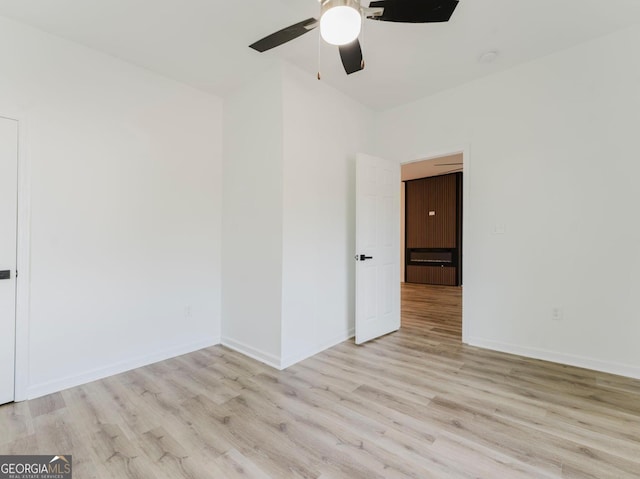 spare room featuring ceiling fan and light hardwood / wood-style flooring