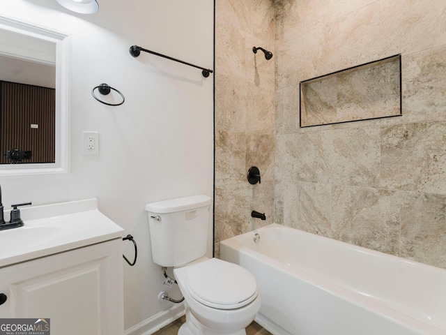 full bathroom featuring vanity, toilet, and tiled shower / bath combo