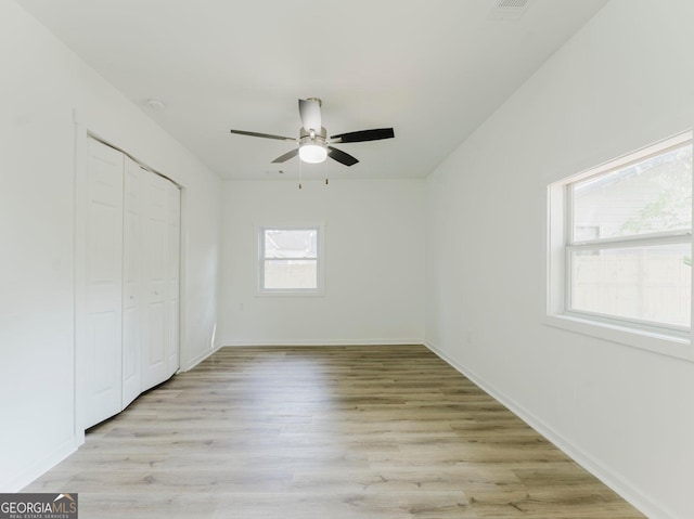 unfurnished bedroom featuring a closet, ceiling fan, and light hardwood / wood-style flooring