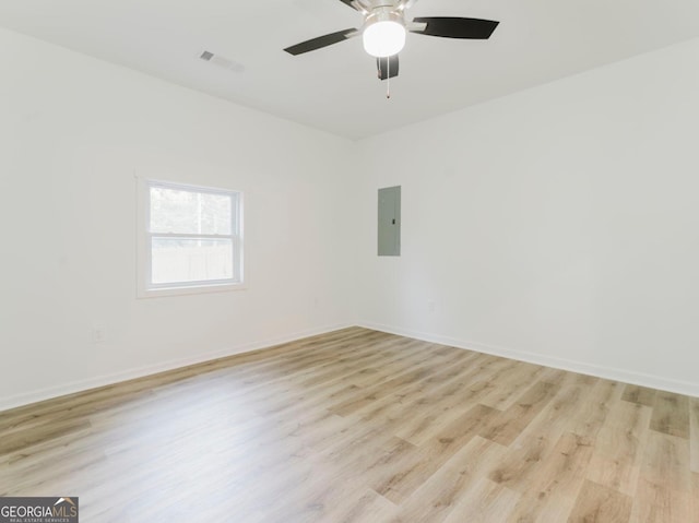 unfurnished room featuring electric panel, ceiling fan, and light wood-type flooring