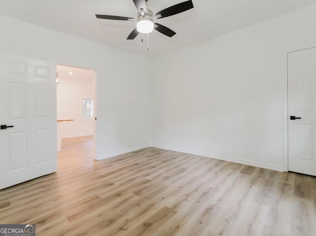 empty room featuring ceiling fan and light wood-type flooring