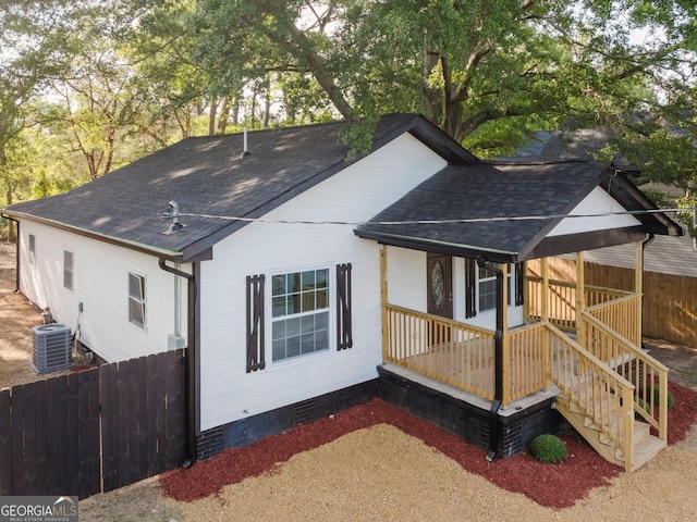 view of side of home featuring a porch and central air condition unit