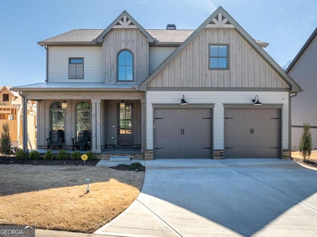 view of front of property featuring a garage, a front yard, and covered porch