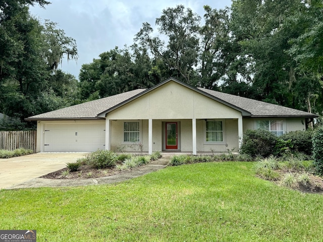 ranch-style house with a garage, a front yard, and covered porch