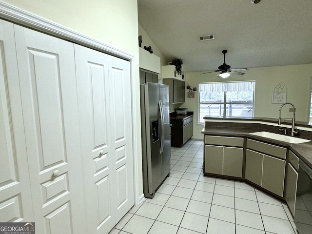 kitchen with light tile patterned floors, stainless steel appliances, sink, lofted ceiling, and ceiling fan