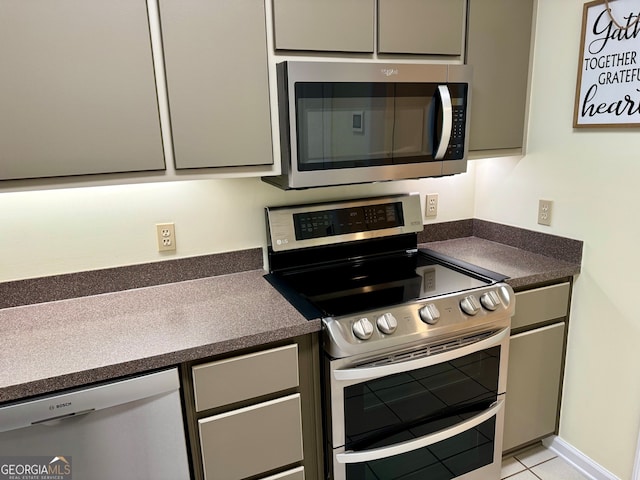 kitchen with appliances with stainless steel finishes and light tile patterned floors