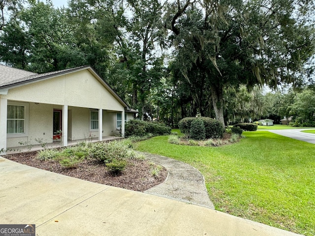 view of yard with covered porch