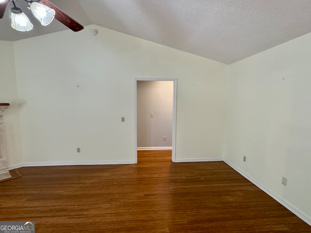 interior space featuring a textured ceiling, ceiling fan, dark hardwood / wood-style floors, and vaulted ceiling