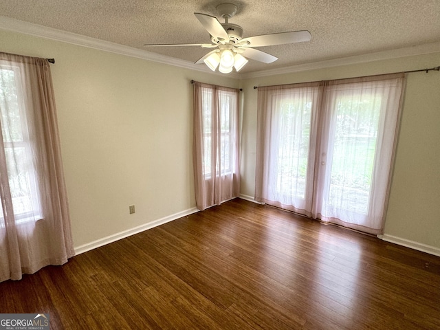 spare room with a textured ceiling, dark wood-type flooring, ceiling fan, and ornamental molding