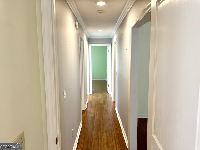 hallway featuring ornamental molding and dark hardwood / wood-style floors