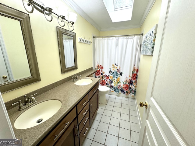 bathroom featuring vanity, tile patterned flooring, toilet, ornamental molding, and a skylight