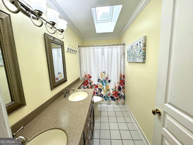 bathroom with a skylight, tile patterned flooring, crown molding, toilet, and vanity