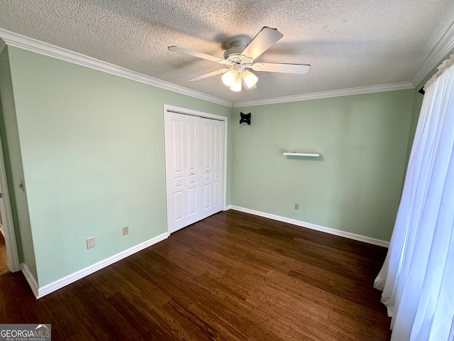 unfurnished bedroom featuring a textured ceiling, dark hardwood / wood-style floors, a closet, ornamental molding, and ceiling fan