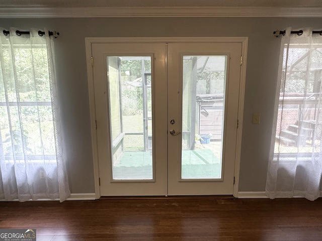 entryway featuring a healthy amount of sunlight, dark hardwood / wood-style flooring, and french doors