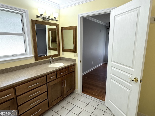 bathroom with hardwood / wood-style flooring, crown molding, and vanity