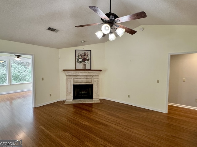 unfurnished living room with a textured ceiling, a premium fireplace, hardwood / wood-style flooring, lofted ceiling, and ceiling fan