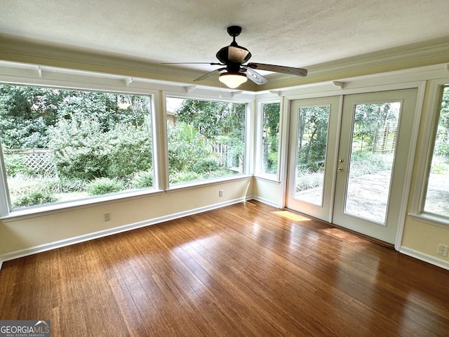 unfurnished sunroom with ceiling fan and french doors