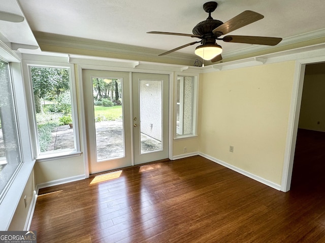 spare room featuring ornamental molding, dark wood-type flooring, french doors, and ceiling fan