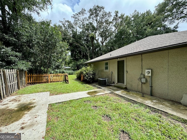 view of yard featuring a patio area and central AC