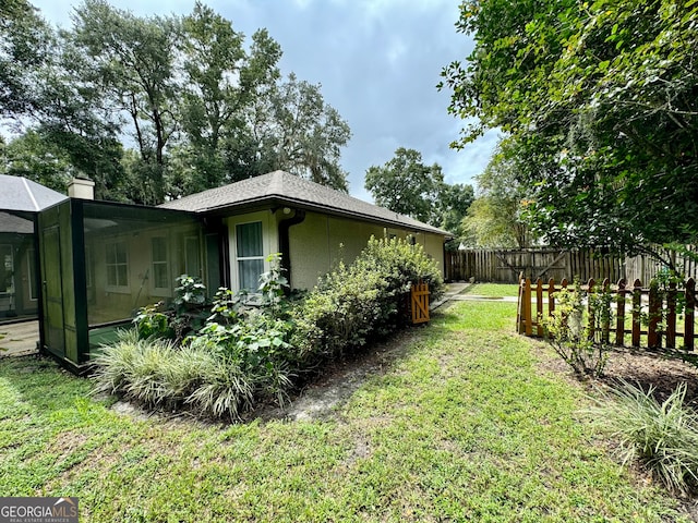 view of yard featuring a sunroom