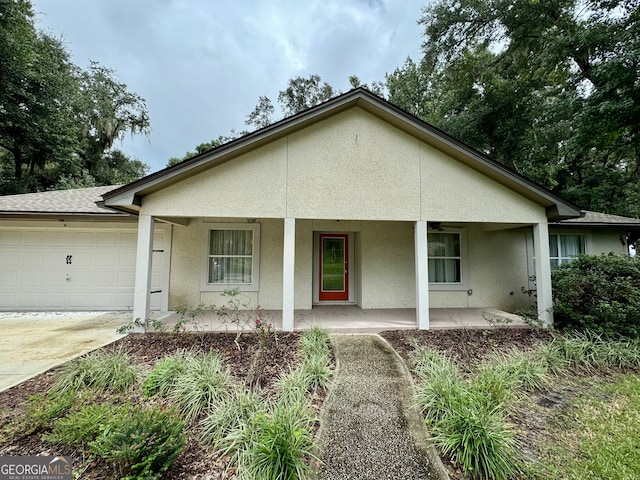 ranch-style house featuring a garage and a porch