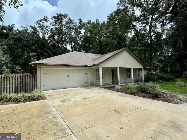 ranch-style home with a garage and covered porch