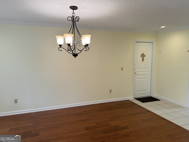 interior space with a textured ceiling, a chandelier, and light hardwood / wood-style floors