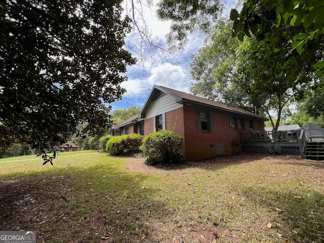 view of property exterior featuring a lawn and a deck