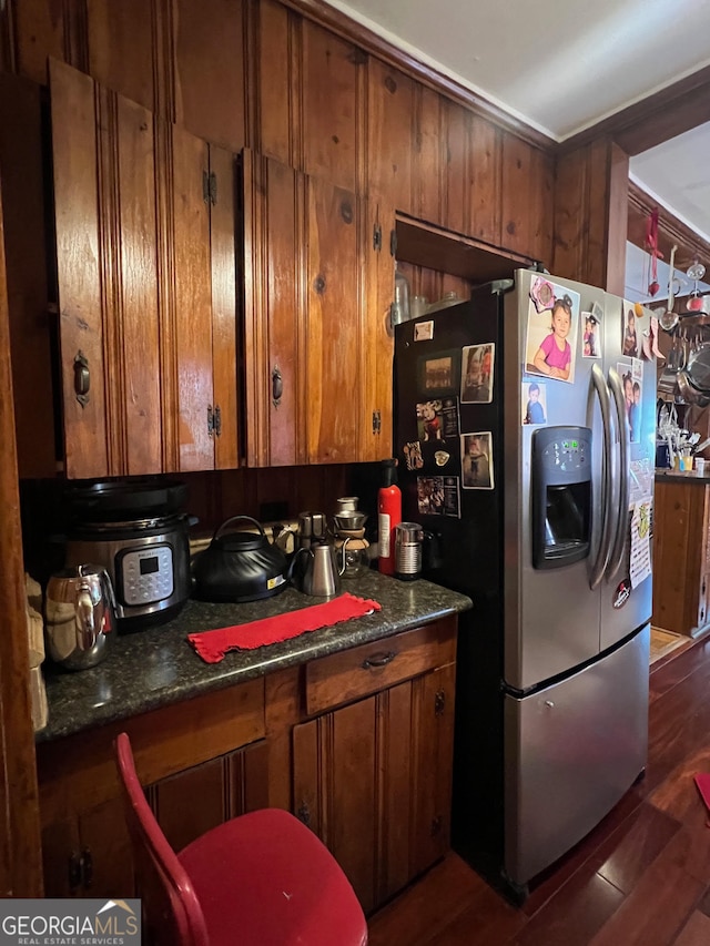 kitchen featuring dark wood-type flooring and stainless steel refrigerator with ice dispenser