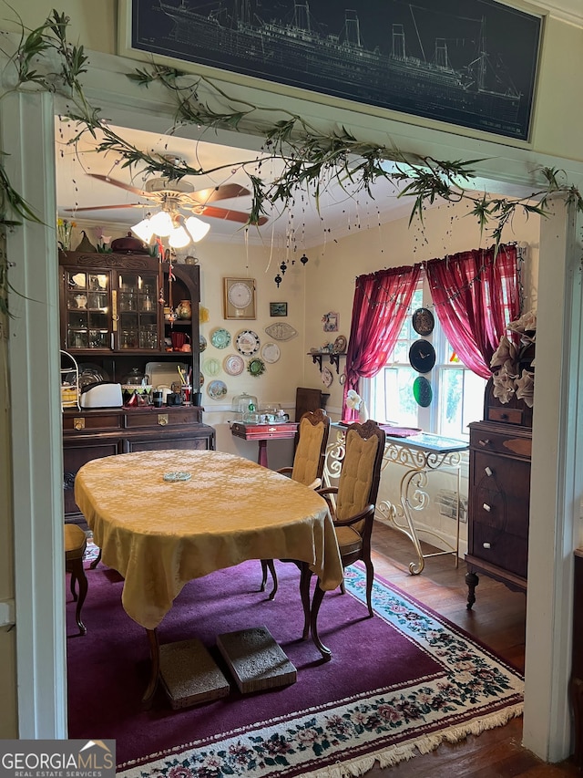 dining space with wood-type flooring and ceiling fan