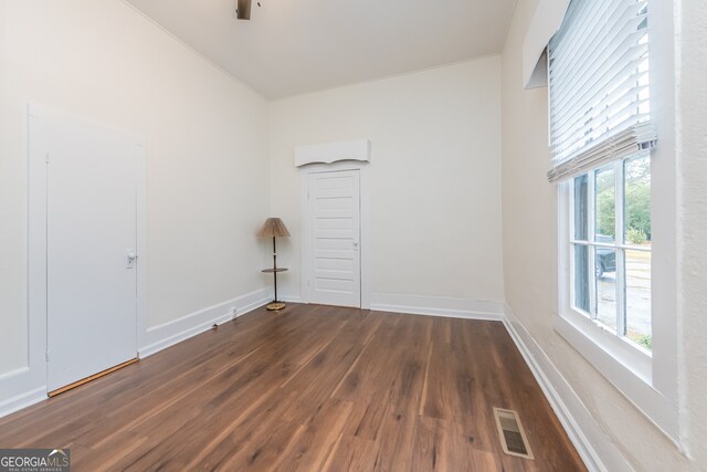 unfurnished room featuring hardwood / wood-style flooring and a healthy amount of sunlight