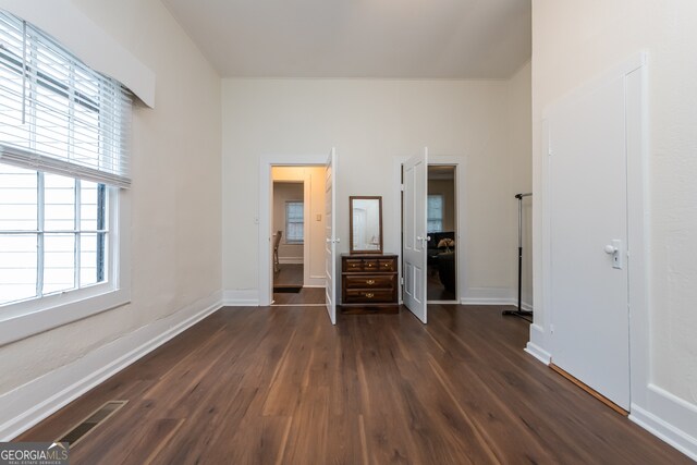 unfurnished bedroom with dark wood-type flooring