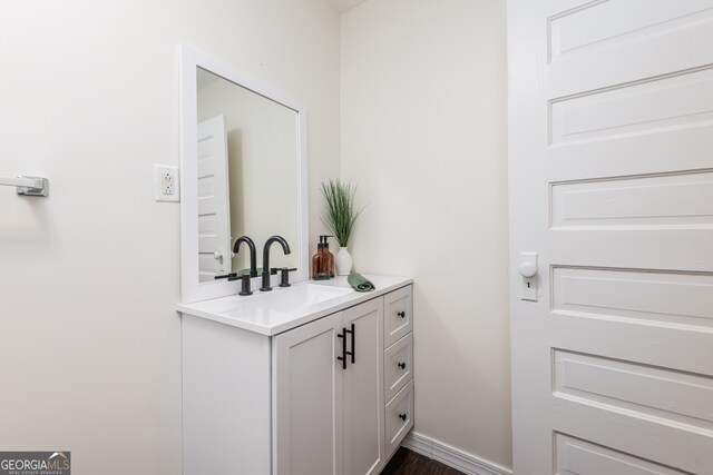 bathroom with vanity and wood-type flooring