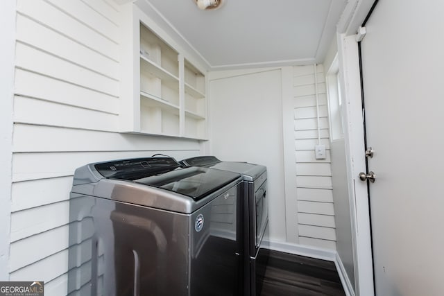 washroom featuring ornamental molding, separate washer and dryer, and dark hardwood / wood-style floors