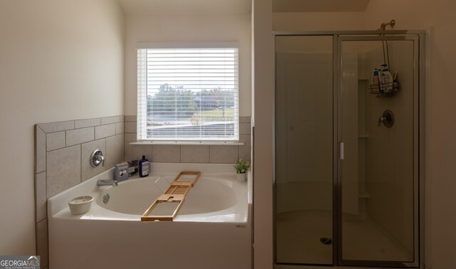 bathroom featuring separate shower and tub