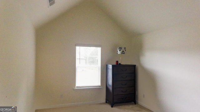 carpeted bedroom with lofted ceiling