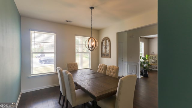 dining area featuring dark hardwood / wood-style floors and a notable chandelier