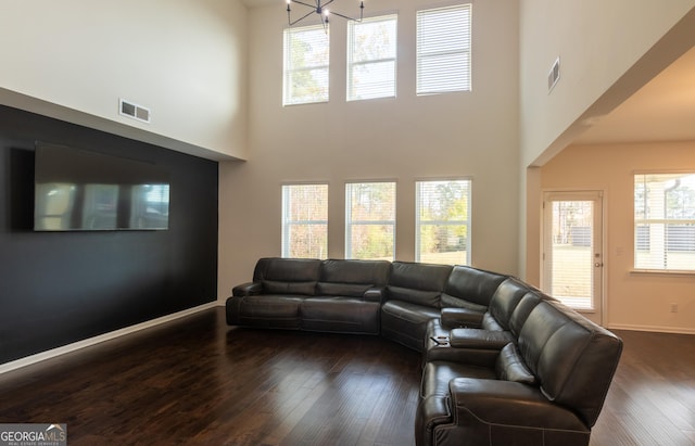 living room featuring dark hardwood / wood-style floors and a high ceiling