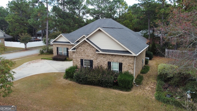 view of side of home with a yard