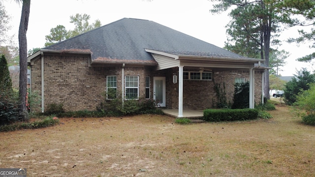 view of front of house with a patio and a front yard