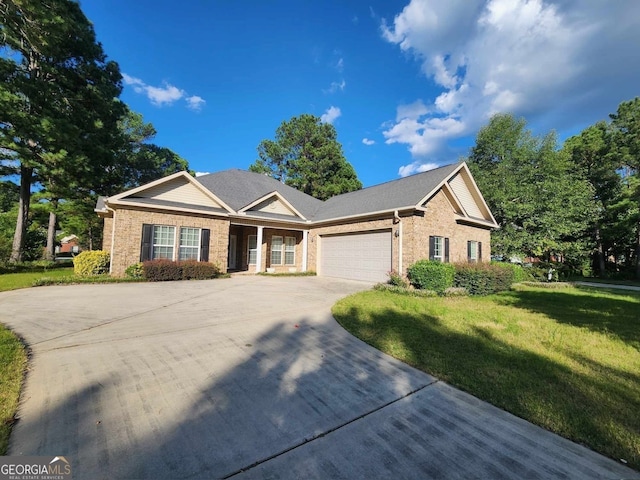 view of front of property featuring a front lawn and a garage