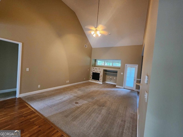 unfurnished living room with high vaulted ceiling, wood-type flooring, and ceiling fan