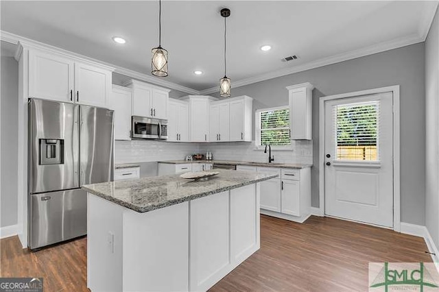 kitchen with a kitchen island, white cabinetry, and stainless steel appliances