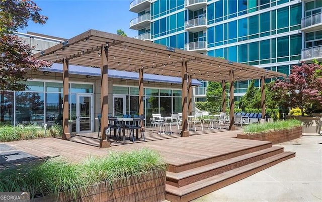 view of home's community featuring a wooden deck, a pergola, and a patio area