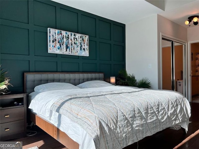 bedroom with wood-type flooring and a closet