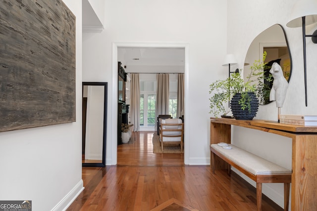 hall with a barn door and dark hardwood / wood-style floors