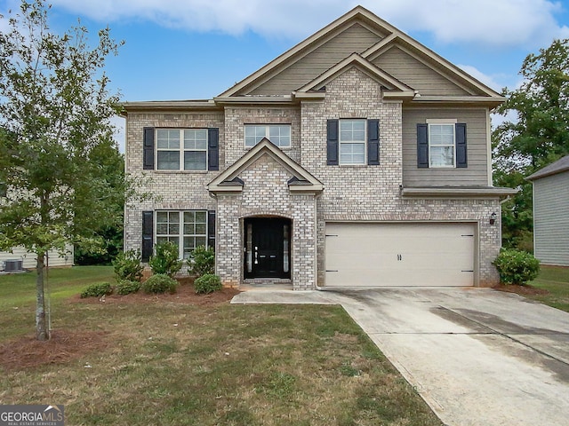 craftsman house with a front yard, cooling unit, an attached garage, concrete driveway, and brick siding