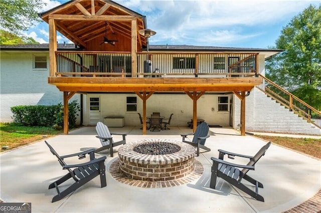 rear view of house featuring stairs, a wooden deck, a patio, ceiling fan, and a fire pit