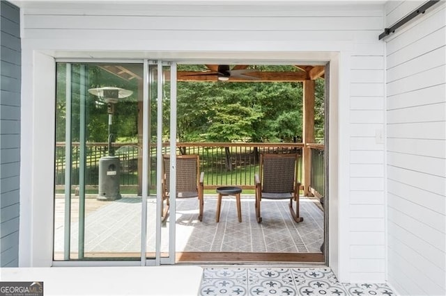 entryway featuring a barn door, a wealth of natural light, and wooden walls